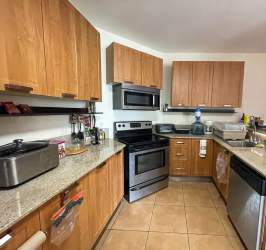 Open living and dining room fully furnished with balcony view of golf course in PH Coronado Golf Tower Panama