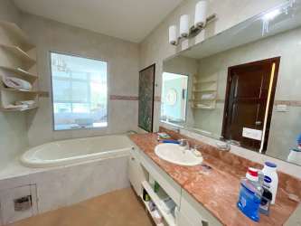 Furnished master bedroom with ensuite jacuzzi bathroom and golf views in Coronado Golf Tower condo Panama