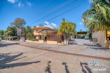 Outdoor pool area surrounded by garden with seating at beachfront hotel Boca Chica Panama
