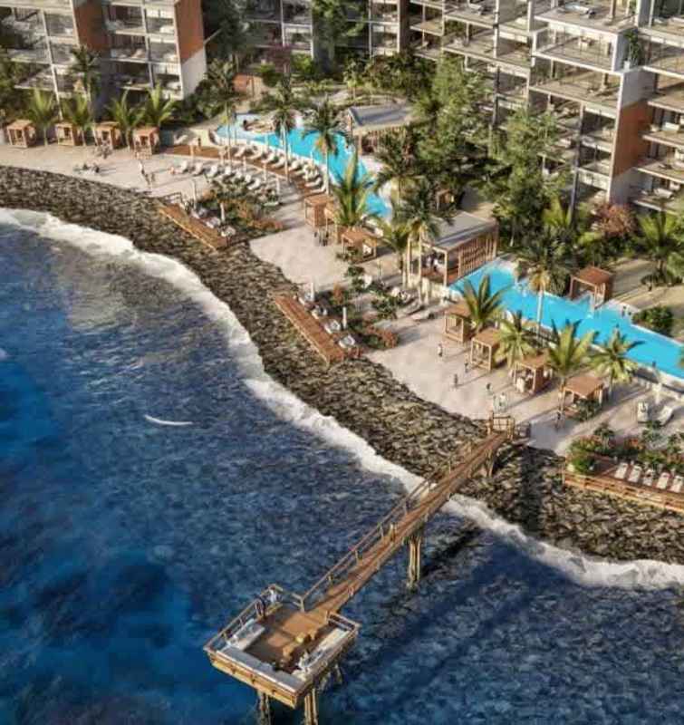 Aerial beachfront luxury resort with pool, pier, tropical landscaping in Ocean Reef Panama City