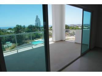 Open plan living area with large sliders and terrace oceanfront Sherman 2