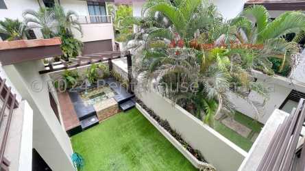 Modern bedroom opens onto balcony with garden views PH Nativa Panama Pacifico