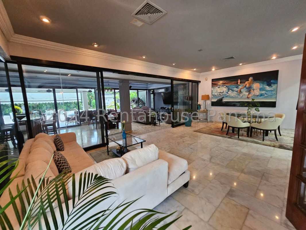 Covered outdoor terrace with barbecue and dining facing garden Panama luxury house
