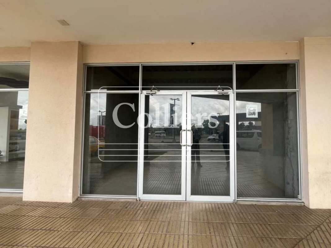 Commercial storefront exterior with large glass doors and parking at Villalobos Pedregal Panama City