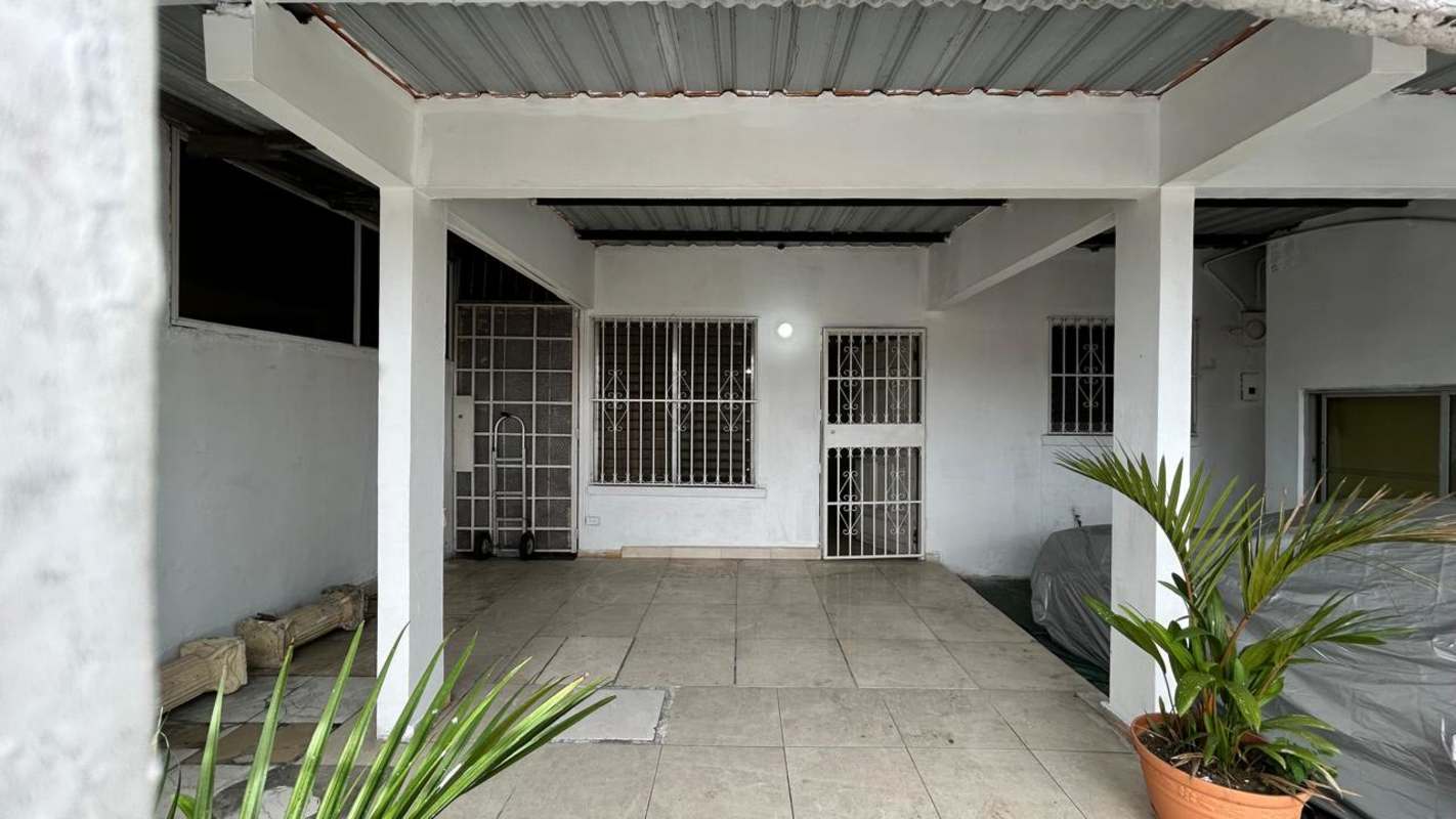 Covered patio area with security bars and tiled floor in Las Mañanitas house for sale