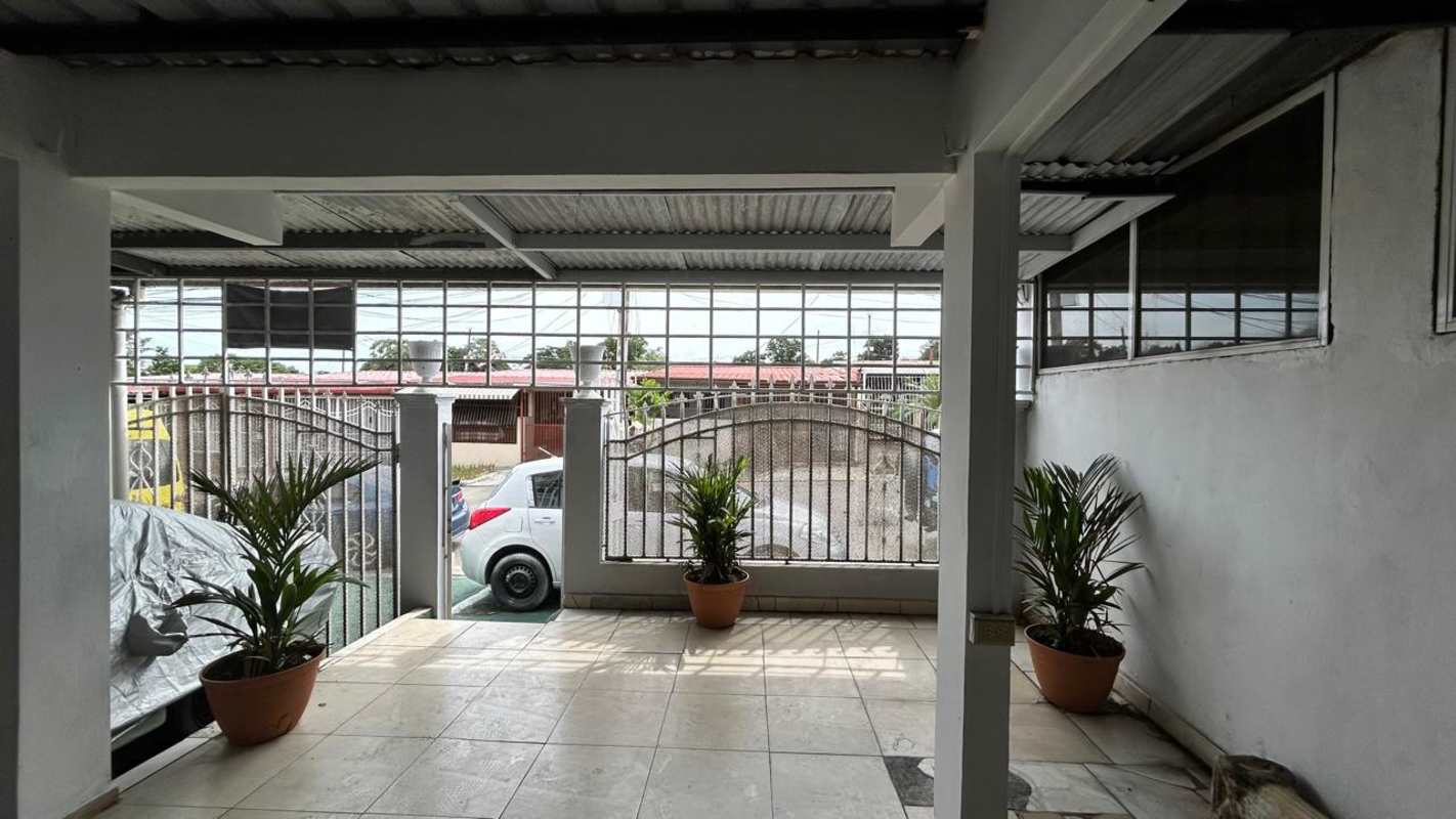Spacious dining room with chandelier and ceiling fans in family home Panama City
