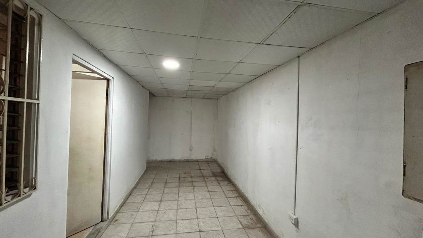 Traditional kitchen with blue tiled countertops and white cabinets in Residencial Las Americas