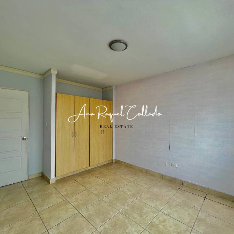 Bedroom with tile flooring, built-in wardrobe, neutral decor in PH Alpes house Panama