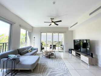 Open concept living and dining with terrace access, modern decor in luxury Buenaventura Panama condo
