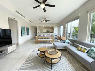 Bright contemporary living area with sectional sofa open to terrace view in Buenaventura Panama condo