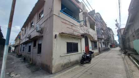 Two-story commercial residential building in Barrio Norte Colón with balconies on corner lot