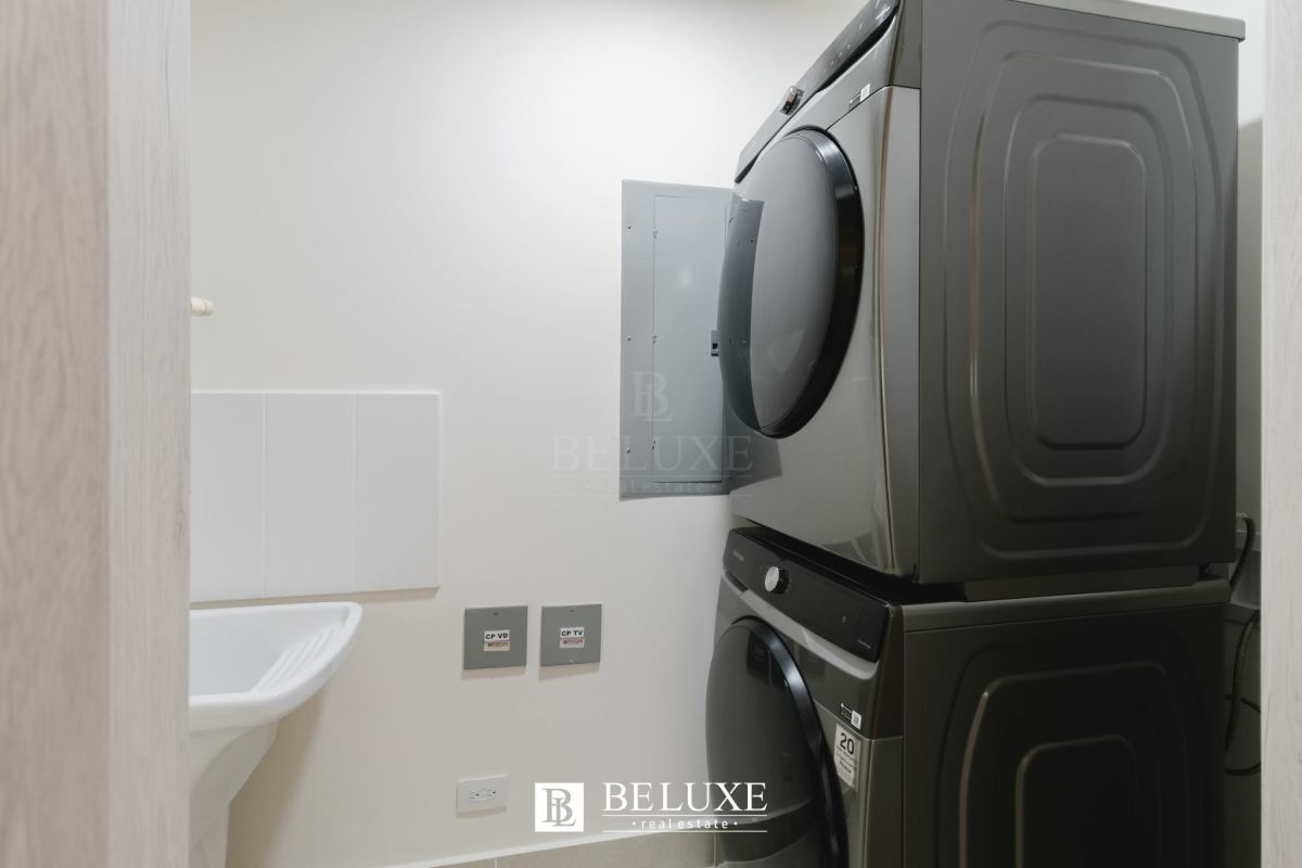 Modern laundry room with washer, dryer, utility sink PH Ocean House Santa Maria Panama