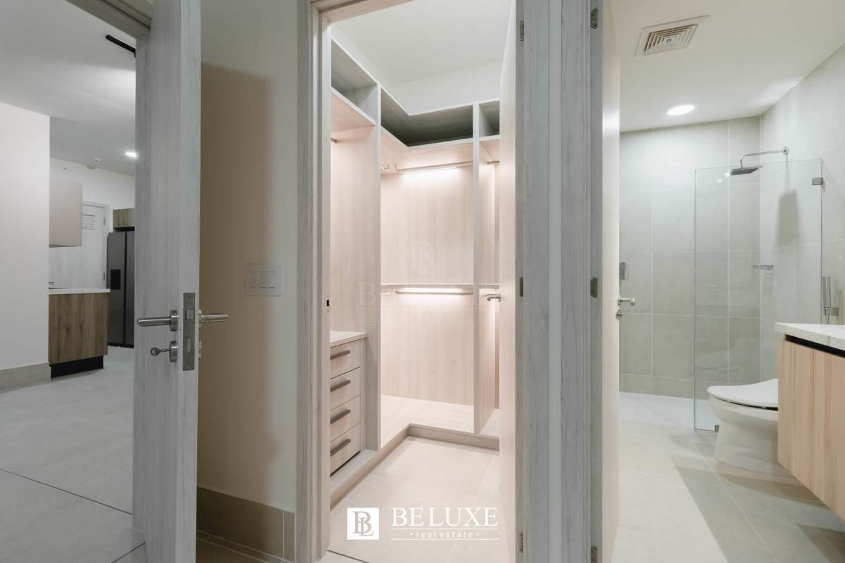 Bright bedroom with panoramic windows and city view at PH Ocean House