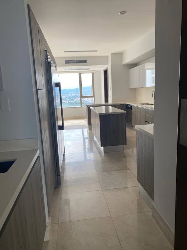 Spacious modern kitchen with island, quartz countertops, built-in appliances at PH GreenGarden Panama City