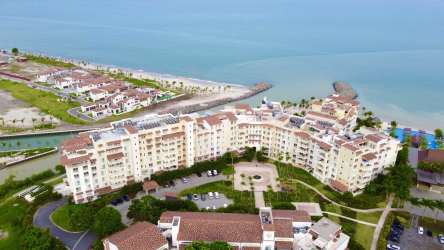 Aerial view of private marina, beachfront condos, lush gardens at Buenaventura Beach Resort Panama