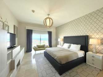 Infinity pool surrounded by palm trees and beachfront setting in Buenaventura Resort Panama