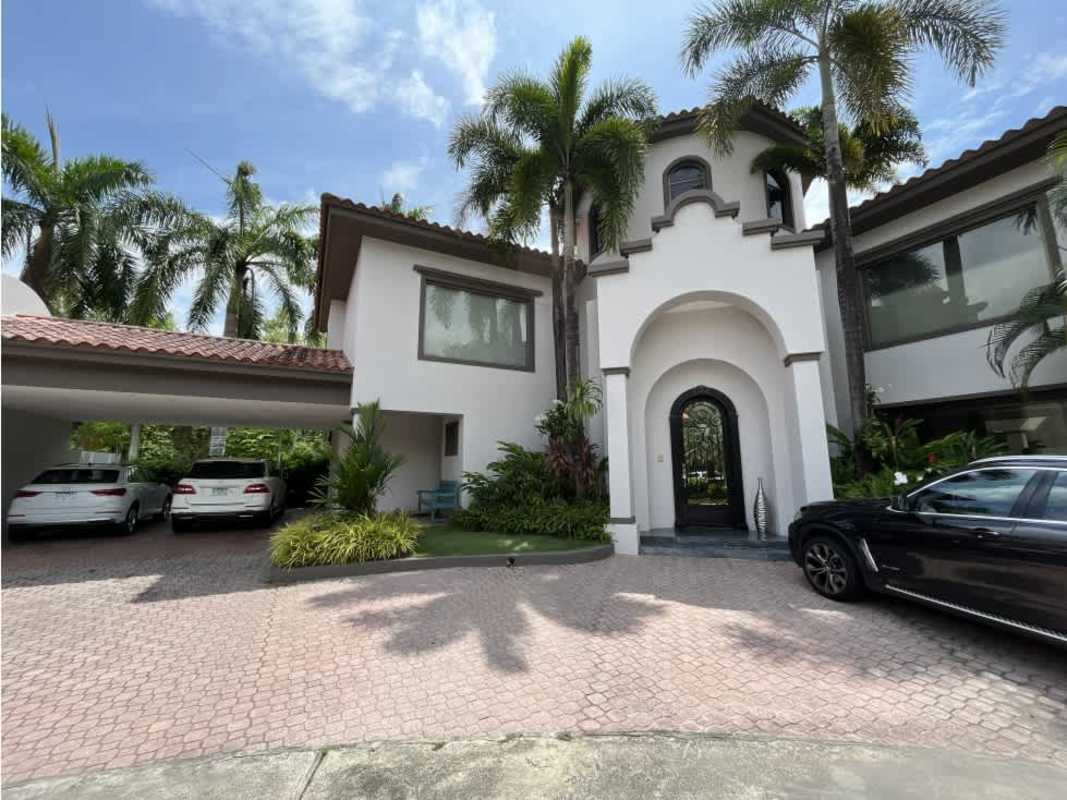 Mediterranean design facade, arched entry tropical landscaping Costa del Este Panama home