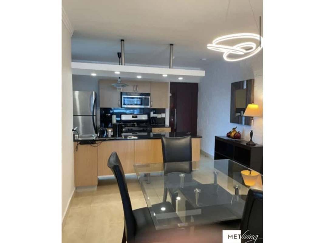 Open kitchen and dining with stainless steel appliances, pendent lighting, modern design at PH Luxor El Cangrejo Panama