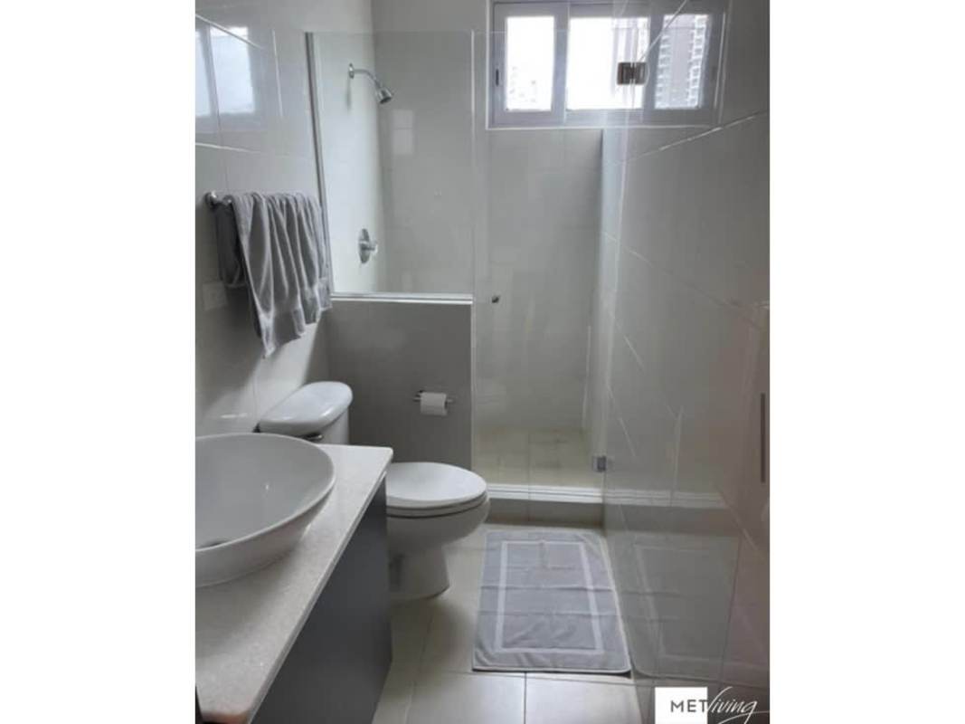 Bathroom with glass-enclosed shower, vessel sink vanity, modern fixtures, window for natural light at PH Luxor El Cangrejo