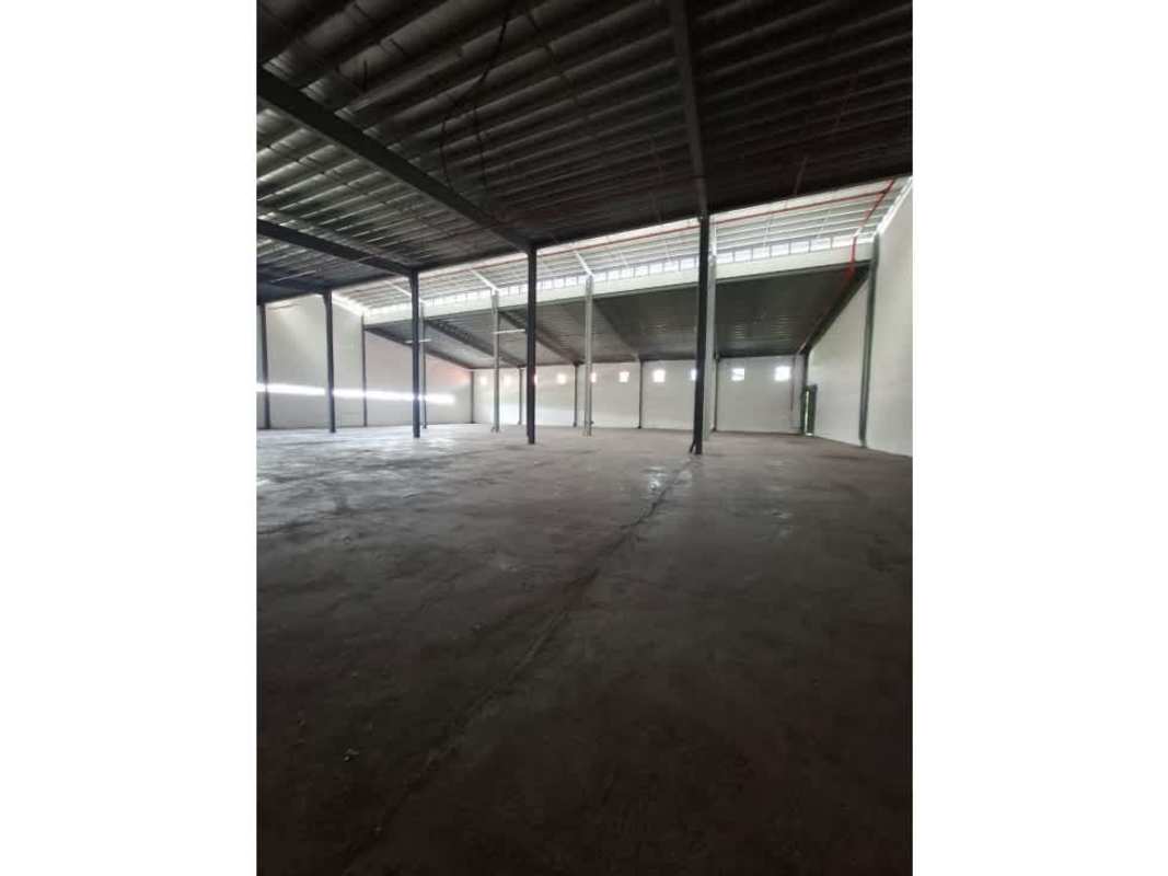 Modern wide hallway with large windows and tiled floor at warehouse for sale in Panama