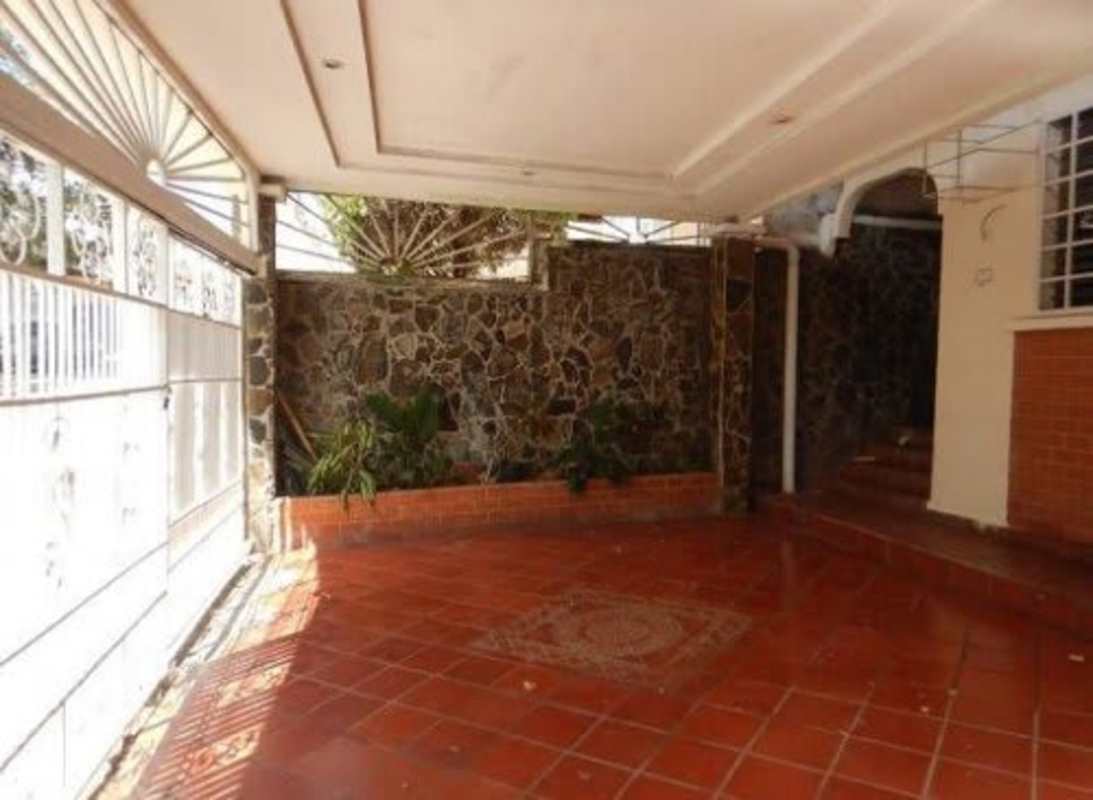 Functional minimalist kitchen with white tile backsplash and sink in Villa Lucre Panama City