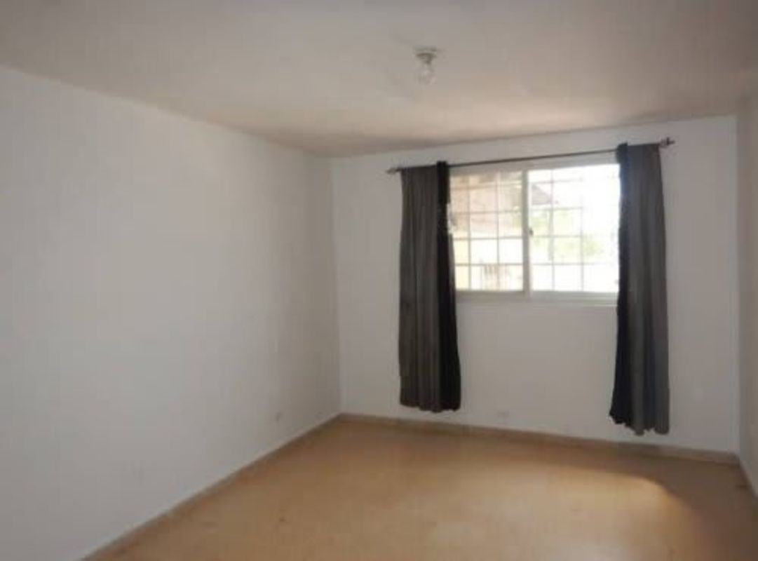 Bedroom with large window, curtains and bars in Villa Lucre Panama City