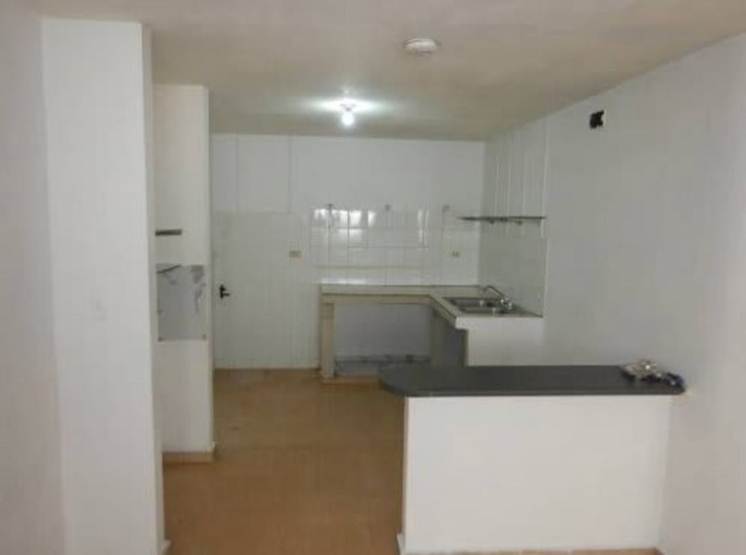 Bedroom with wooden closet and en suite bathroom view in Villa Lucre Panama City