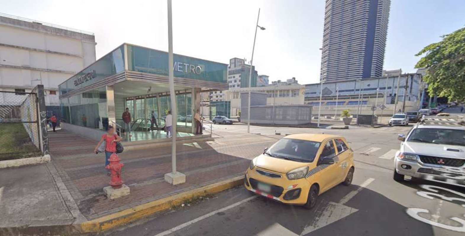 Glass metro station entrance with pedestrians near commercial lot for sale Bella Vista Panama