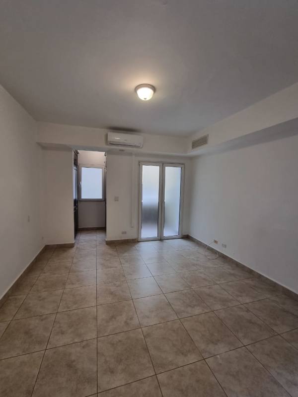 Spacious living area with arch windows, neutral palette in Tucan Country Club condo