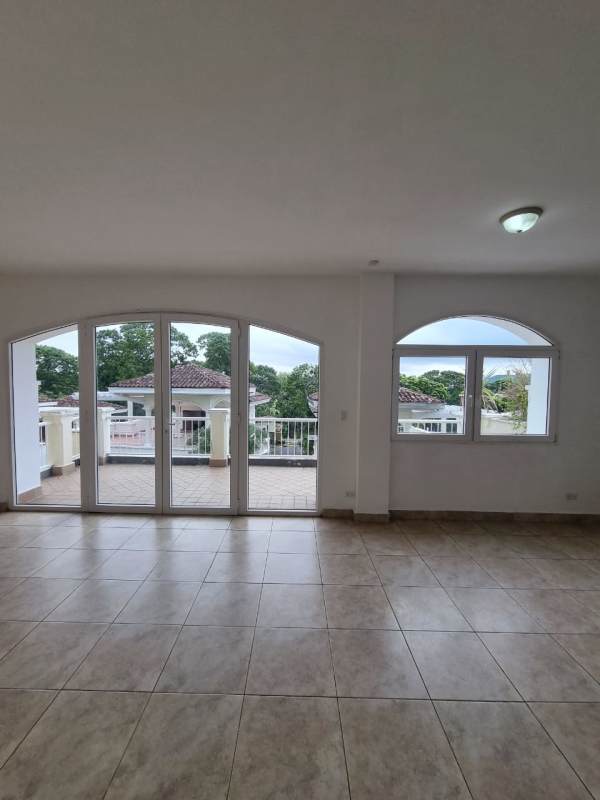Open living space with balcony views and arched Mediterranean windows in Tucan Country Club