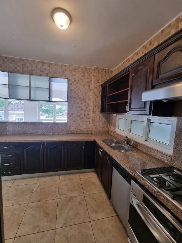 Empty living room with split AC, white walls, tile floor in Tucan golf condo Panama