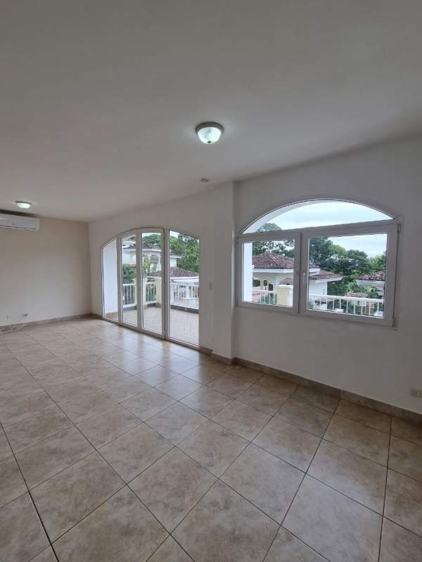Bright living area with arched glass doors, porcelain tile floor in Tucan Country Club