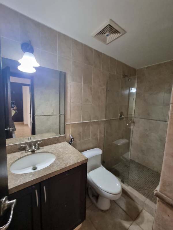 Laundry area with washer dryer hookups, water heater, tiled walls in Tucan Country Club apartment