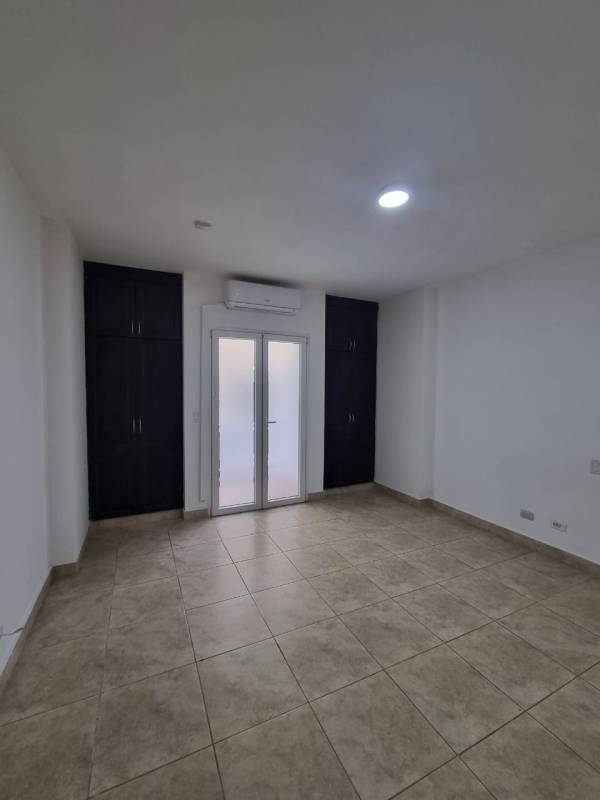 Contemporary bathroom with glass-enclosed shower and vanity in Tucan Country Club apartment