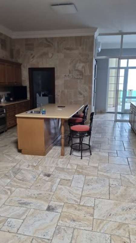 Open spacious kitchen with island, natural stone accents PH Bellagio Punta Pacífica