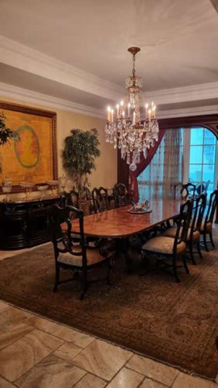 Classically styled living room with marble floors, chandeliers and ocean backdrop in PH Bellagio Panama