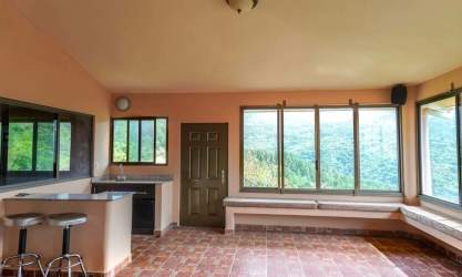 Bright sunroom and breakfast nook large windows mountain scenery in Altos del Maria Panama