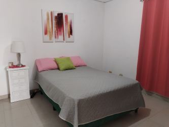 Bedroom with bed natural lighting and windows affordable house Panama