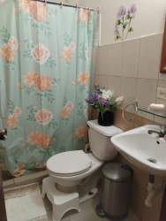 Covered laundry area with washer setup in affordable house La Chorrera