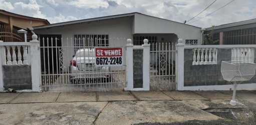 Gated driveway and facade of affordable house in Jardines de Mastranto La Chorrera Panama
