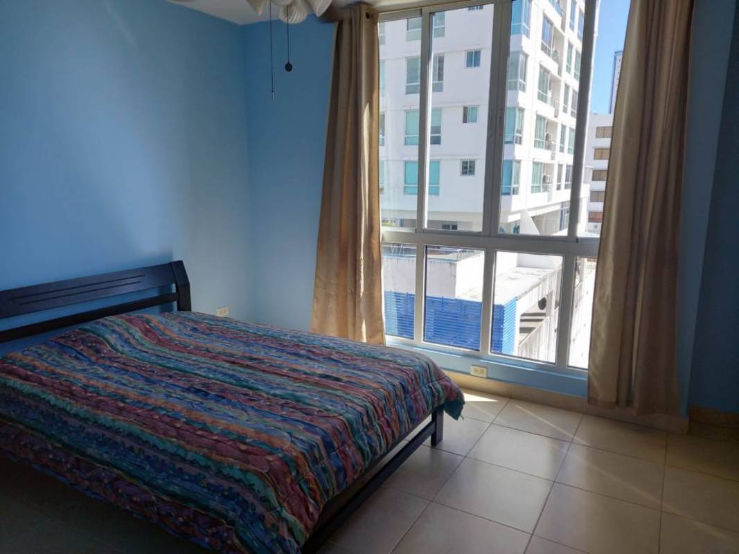 Open plan dining and living room with green accent walls at PH Portofino San Francisco Panama City