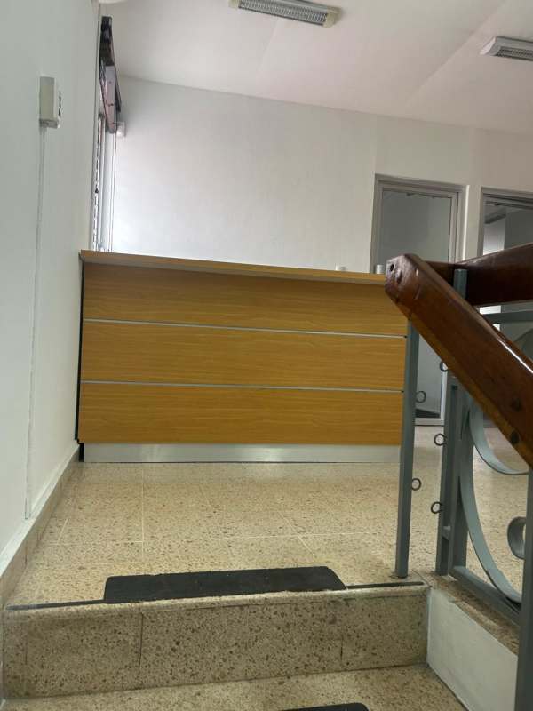 Upstairs reception area with wooden desk and tiled floor Office House Coco del Mar