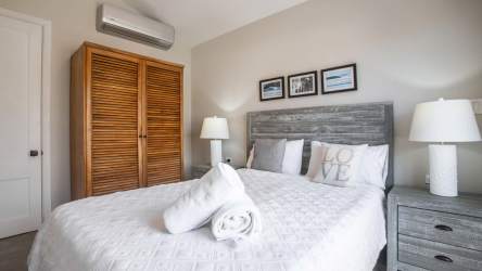 Modern bedroom with wood accents AC and artwork in Blue Venao Playa Venao luxury villa
