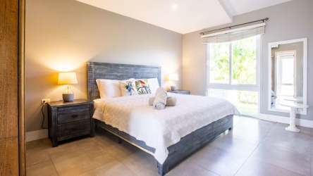 Bright coastal bedroom with large bed rattan headboard Blue Venao Playa Venao Panama