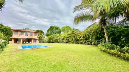 Large private swimming pool surrounded by tropical landscaped garden in Buenaventura Resort Panama