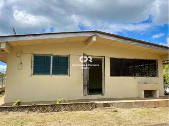 Facade with beige single story commercial building with garden Santiago Panama