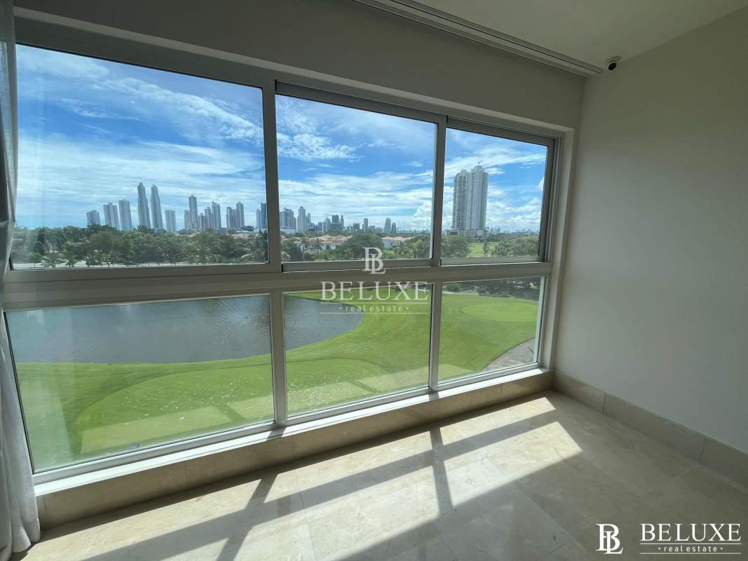 Spacious living room with floor-to-ceiling glass and golf view in Santa Maria apartment