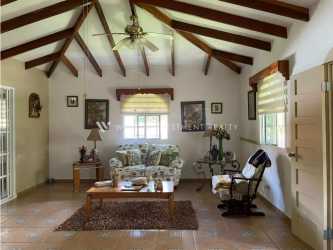 Rustic style living room with wood beams and ceramic tile in Coronado Golf house Panama