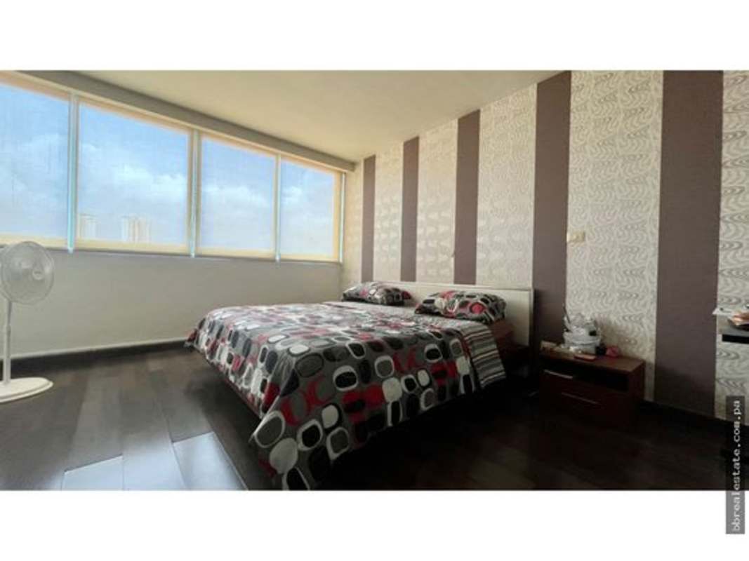 Modern bedroom with city views, large windows, and elegant design at PH Soho Tower Panama
