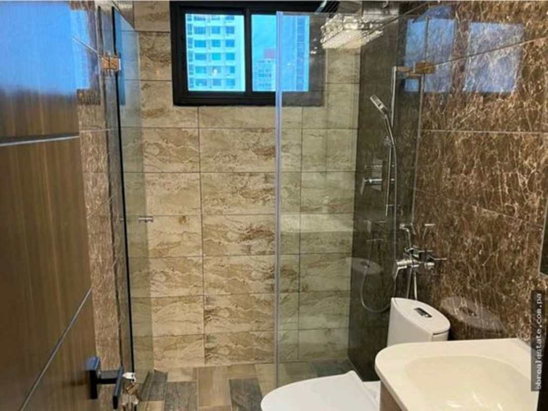 Contemporary bathroom with glass walk-in shower, marble wall tiles, elegant fixtures PH Country Park Panama